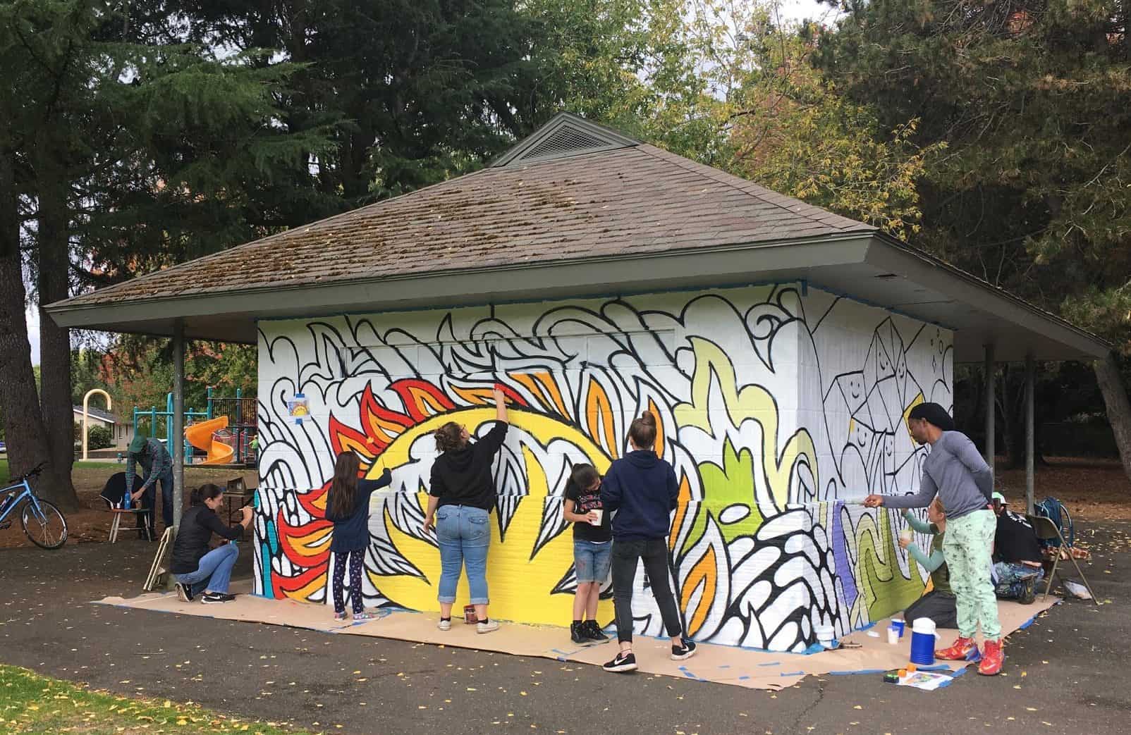 Volulnteers painting the walls of the Essex Park public restroom